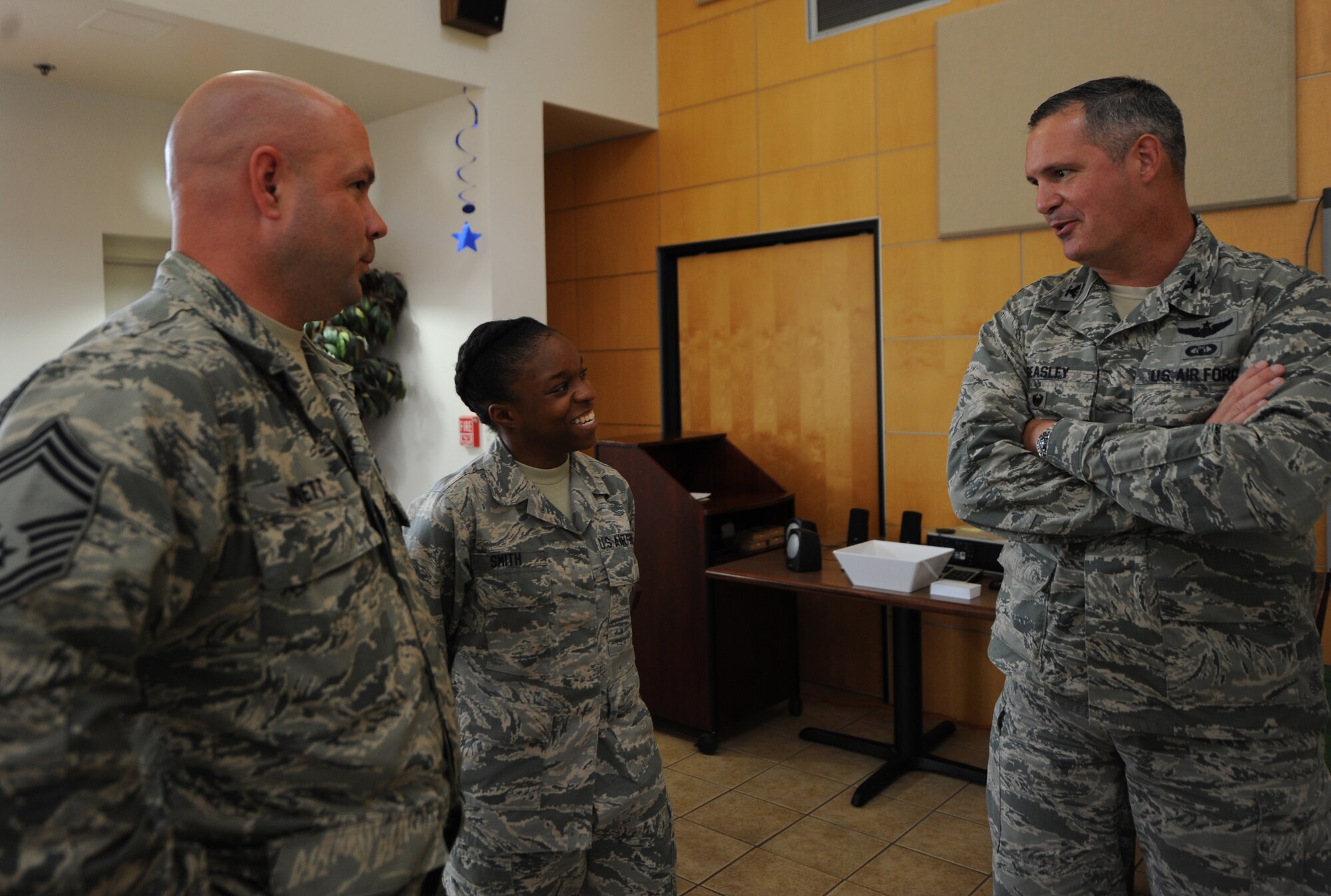 U.S. Air Force Airman 1st Class Kyrah Smith, 7th Medical Group, speaks with Col. Steven Beasley, 7th Bomb Wing vice commander, and Chief Master Sgt. Aaron Bennett, 7th Mission Support Group, before a cake cutting ceremony Sept. 18, 2014, at Dyess Air Force Base, Texas. The cake cutting ceremony was in celebration of the Air Force’s 67th birthday. (U.S. Air Force photo by Airman 1st Class Alexander Guerrero/Released)