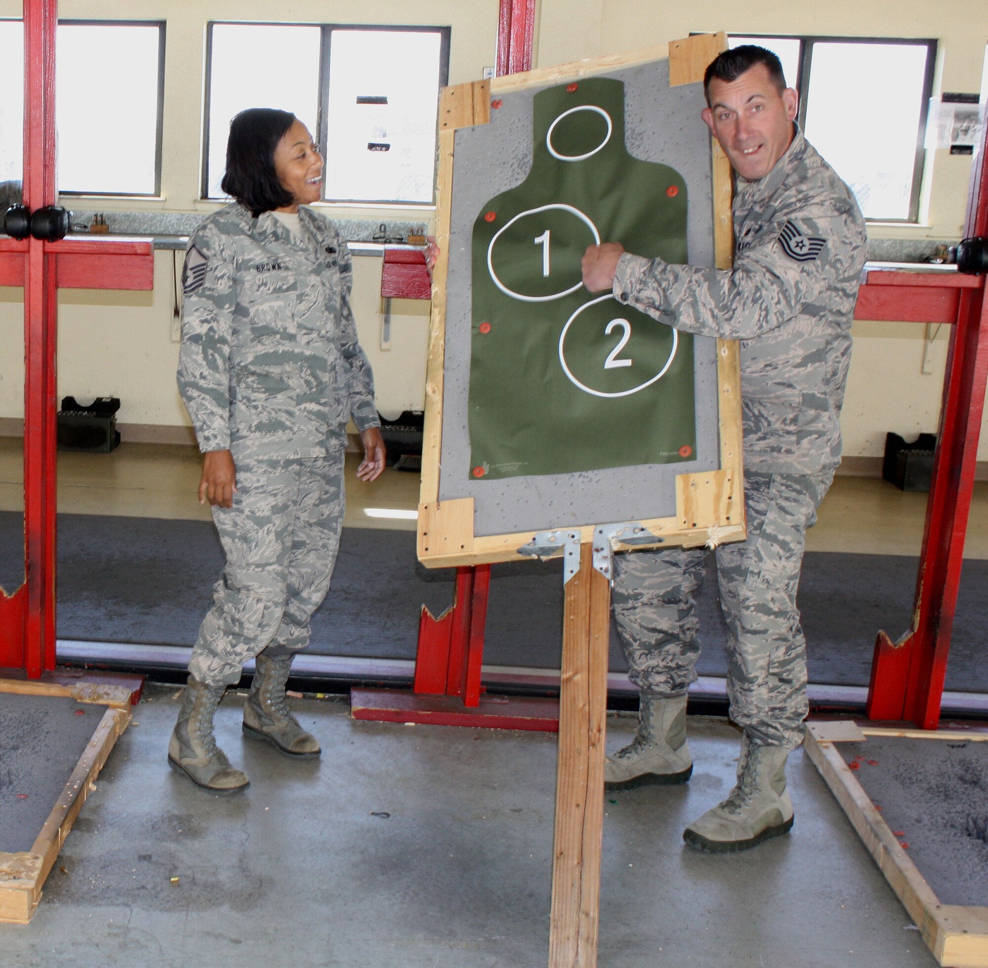 TRAVIS AIR FORCE BASE, Calif. -- "I’ll put one right here, he’s a dead man." Tech. Sgt. Bill Pullion indicates to Master Sgt. Michaela Brown where his shot will go, as they get ready to fire on the range. During the 349th Air Mobility Wing Recruiting Squadron’s Fourth Quarter Operations and Training meeting, the recruiting team took time out for a team building exercise at the Travis Air Force Base Combat Arms Training range. (U.S. Air Force photo/Senior Master Sgt. Alexander Brown)
