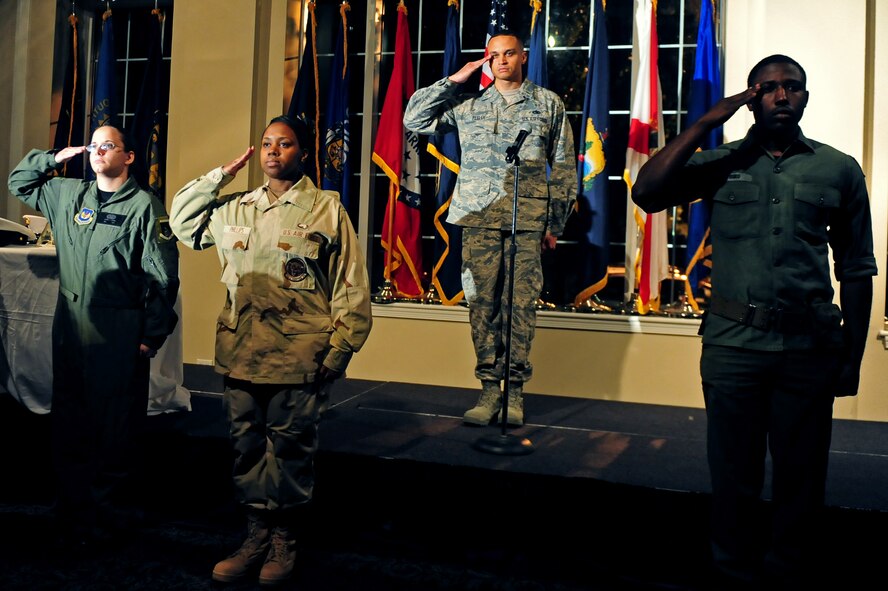 Airmen salute as part of a dramatic presentation during the Seymour Johnson Air Force Base Air Force Ball on Sept. 20, 2014, at Seymour Johnson Air Force Base, North Carolina. The event featured a performance entitled "Moments In Time" by Airmen throughout the wing portraying fictional characters telling their stories of losing loved ones in combat or the line of duty. The Airmen, acting as characters from key eras in military history, gave fictional accounts of what the experience may have felt like for those who lived through the loss of a loved one.  The goal of the performance was to honor fallen service members and first responders. The ball also featured a silent auction, dinner and dancing. (U.S. Air Force photo/Airman 1st Class Brittain Crolley)