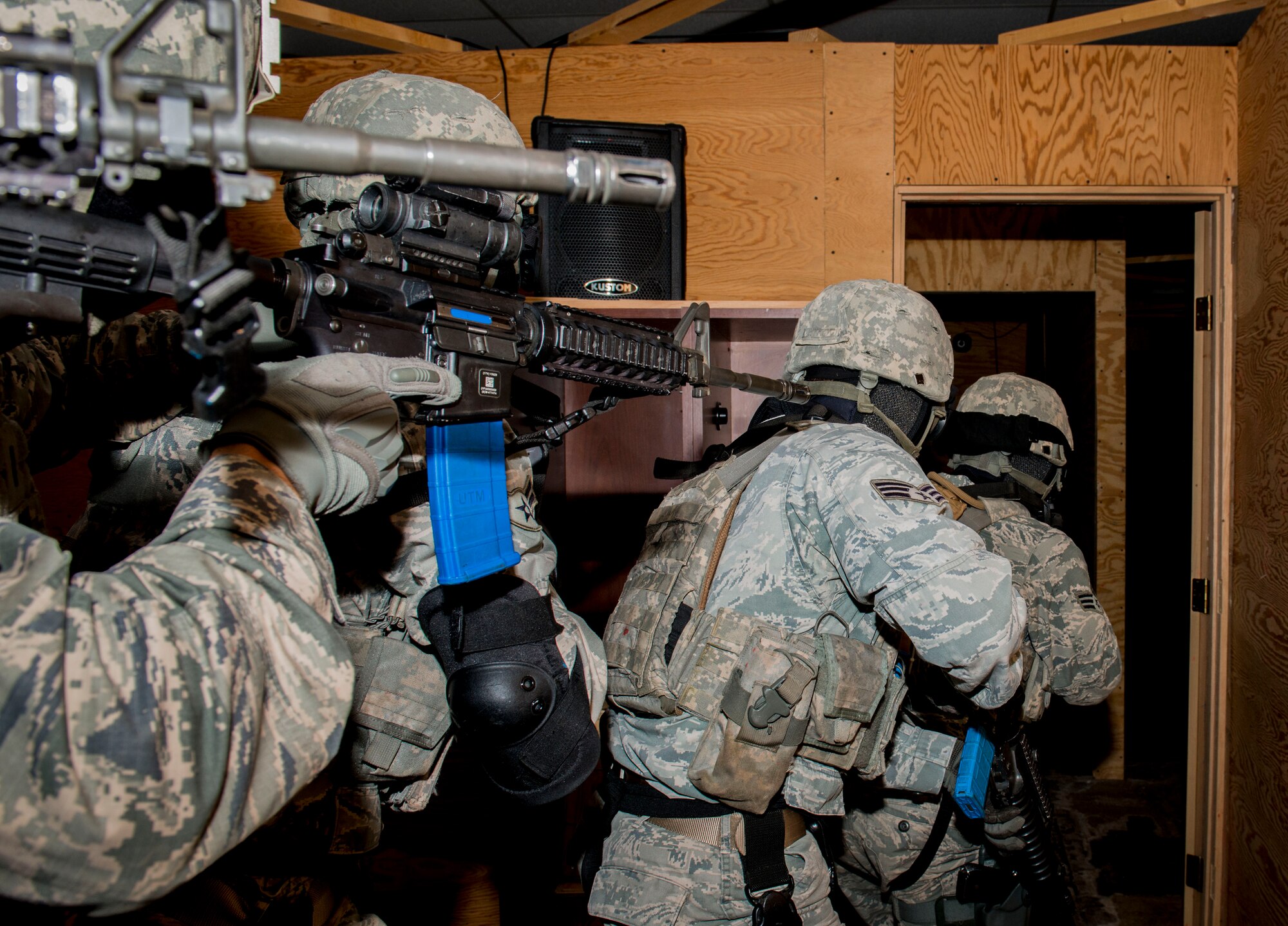 Members of the 5th Security Forces Squadron prepare to clear a room during a simulated full assault on Minot Air Force Base, N.D., Sept. 17, 2014. The team fired blanks to simulate a hostile situation in preparation for the 2014 Air Force Global Strike Challenge. (U.S. Air Force photo/Airman 1st Class Sahara L. Fales)