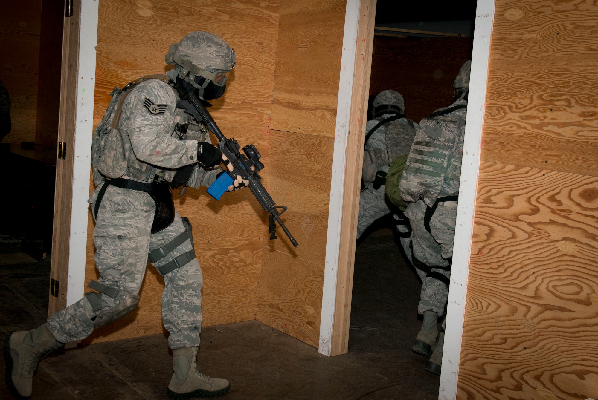 Staff Sgt. Rodrique Welton, 5th Security Forces Squadron Global Strike Challenge fire team leader, follows his teammates throughout the shoot house during a simulated full assault on Minot Air Force Base, N.D., Sept. 17, 2014. The team practiced locating a hidden individual in preparation for the 2014 Air Force Global Strike Challenge. (U.S. Air Force photo/Airman 1st Class Sahara L. Fales)