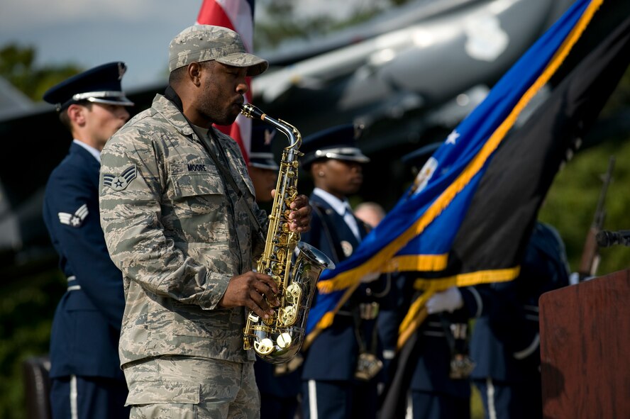 Senior Airman Kailyn Moore, 4th Operations Support Squadron aircrew flight equipment specialist, plays the National Anthem during the POW/MIA Ceremony on Sept. 19, 2014, at Seymour Johnson Air Force Base, North Carolina. The ceremony, held in conjunction with national POW/MIA Recognition Day, featured a missing-man formation flyover by four F-15E Strike Eagles assigned to the 4th Fighter Wing, a reading of the Code of Conduct, a special presentation of the colors and remarks by both Col. Mark Slocum, 4th FW commander, and retired Army colonel and Medal of Honor recipient Walter J. Marm. (U.S. Air Force photo/Airman 1st Class Aaron Jenne)