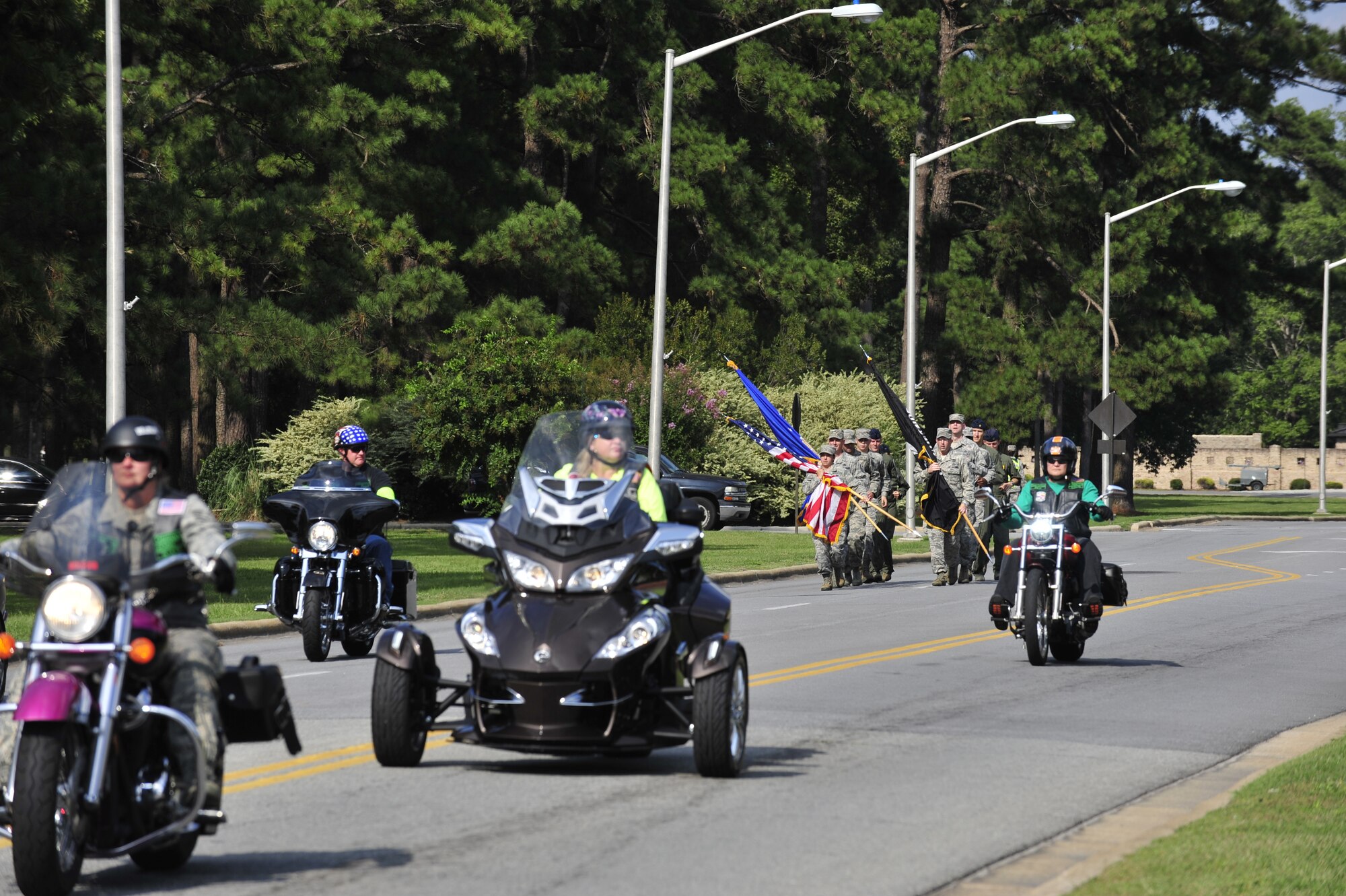 The Green Knights and the Guardian Brotherhood, both motorcycle groups who honor service members, first responders and members of the Department of Defense, escort the POW/MIA flag bearers prior to the POW/MIA Ceremony on Sept. 19, 2014, at Seymour Johnson Air Force Base, North Carolina. The ceremony, held in conjunction with national POW/MIA Recognition Day, featured a missing-man formation flyover by four F-15E Strike Eagles assigned to the 4th Fighter Wing, a reading of the Code of Conduct, a special presentation of the colors and remarks by both Col. Mark Slocum, 4th FW commander, and retired Army colonel and Medal of Honor recipient Walter J. Marm. (U.S. Air Force photo/Airman 1st Class Aaron Jenne)