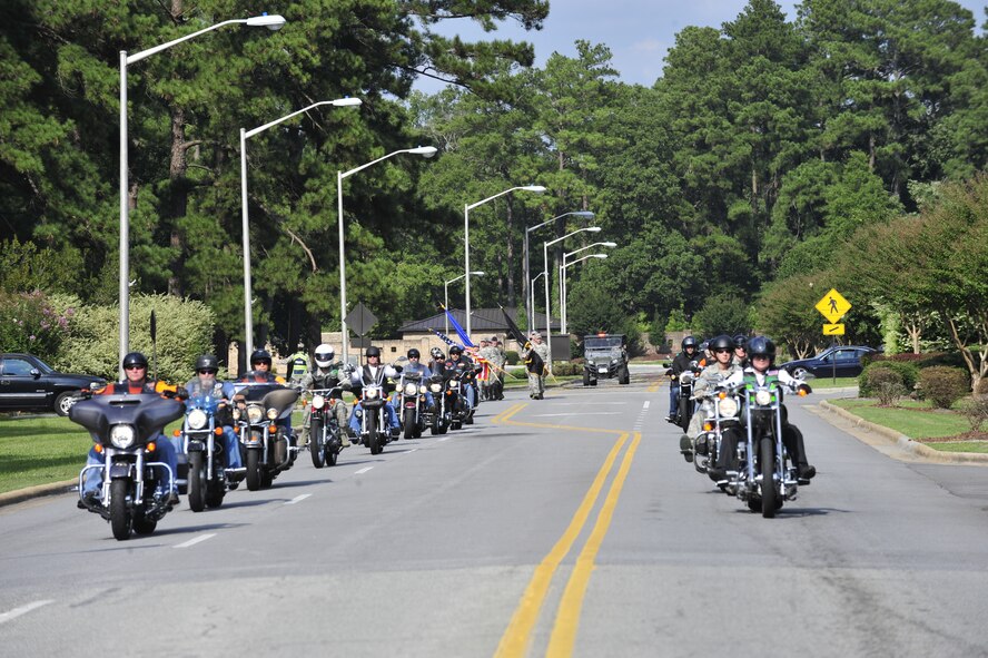 The Green Knights and the Guardian Brotherhood, both motorcycle groups who honor service members, first responders and members of the Department of Defense, escort the POW/MIA flag bearers prior to the POW/MIA Ceremony on Sept. 19, 2014, at Seymour Johnson Air Force Base, North Carolina. The ceremony, held in conjunction with national POW/MIA Recognition Day, featured a missing-man formation flyover by four F-15E Strike Eagles assigned to the 4th Fighter Wing, a reading of the Code of Conduct, a special presentation of the colors and remarks by both Col. Mark Slocum, 4th FW commander, and retired Army colonel and Medal of Honor recipient Walter J. Marm. (U.S. Air Force photo/Airman 1st Class Aaron Jenne)