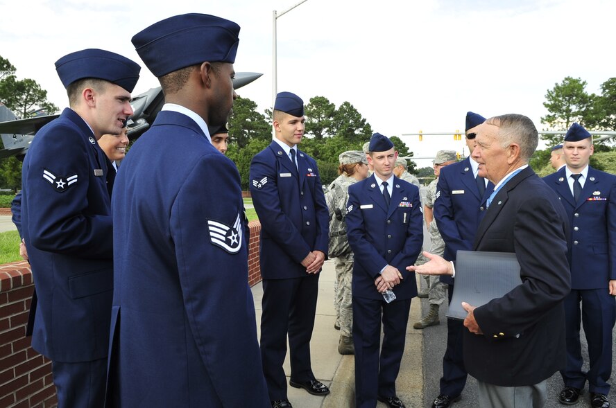 Retired Army colonel and Medal of Honor recipient, Walter J. Marm (right), talks with 4th Fighter Wing Airmen following the POW/MIA Ceremony on Sept. 19, 2014, at Seymour Johnson Air Force Base, North Carolina. The ceremony, held in conjunction with national POW/MIA Recognition Day, featured a missing-man formation flyover by four F-15E Strike Eagles assigned to the 4th FW, a reading of the Code of Conduct, a special presentation of the colors and remarks by both Marm and Col. Mark Slocum, 4th FW commander. (U.S. Air Force photo/Airman 1st Class Shawna Keyes)