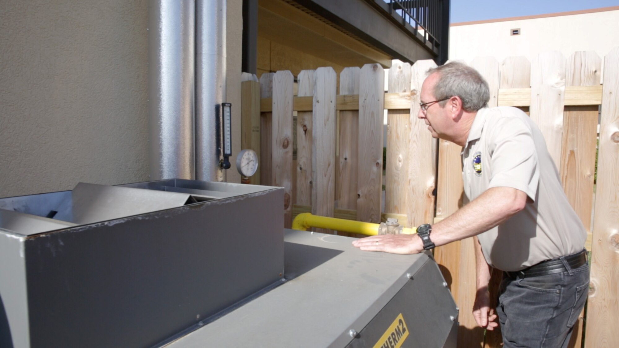 Rex Stanford, energy savings performance contract project manager at Tinker AFB, Okla., examines gauge readings on one of 56 new high-efficiency natural-gas fired boilers installed throughout the base as part of the $80.6 million ESPC. (U.S. Air Force photo/Eddie Green/Released) 