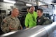 U.S. Army Sgt. Jonzachary Glass (left), Alpha Battery canon crew member, instructs Will Krajewski (right), and his father, Joe, on a canon Sept. 19, 2014, during his Pilot for a Day tour at Joint Base Lewis-McChord, Wash. During his tour, Krajewski was able to see some of the different U.S. Army’s equipment which was loaded onto the C-17 Globemaster III. (U.S. Air Force photo/Airman 1st Class Keoni Chavarria)