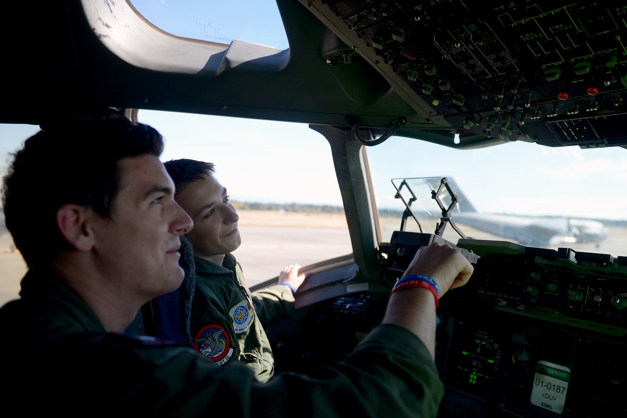 1st Lt. Christopher Lee (left), 4th Airlift Squadron pilot, identifies to Will Krajewski, what the different buttons and knobs do in a C-17 Globemaster III Sept. 19, 2014, during his Pilot for a Day tour at Joint Base Lewis-McChord, Wash. Krajewski learned about the different parts and functions of the C-17 along with the duties of the Airmen that work on the aircraft. (U.S. Air Force photo/Airman 1st Class Keoni Chavarria)