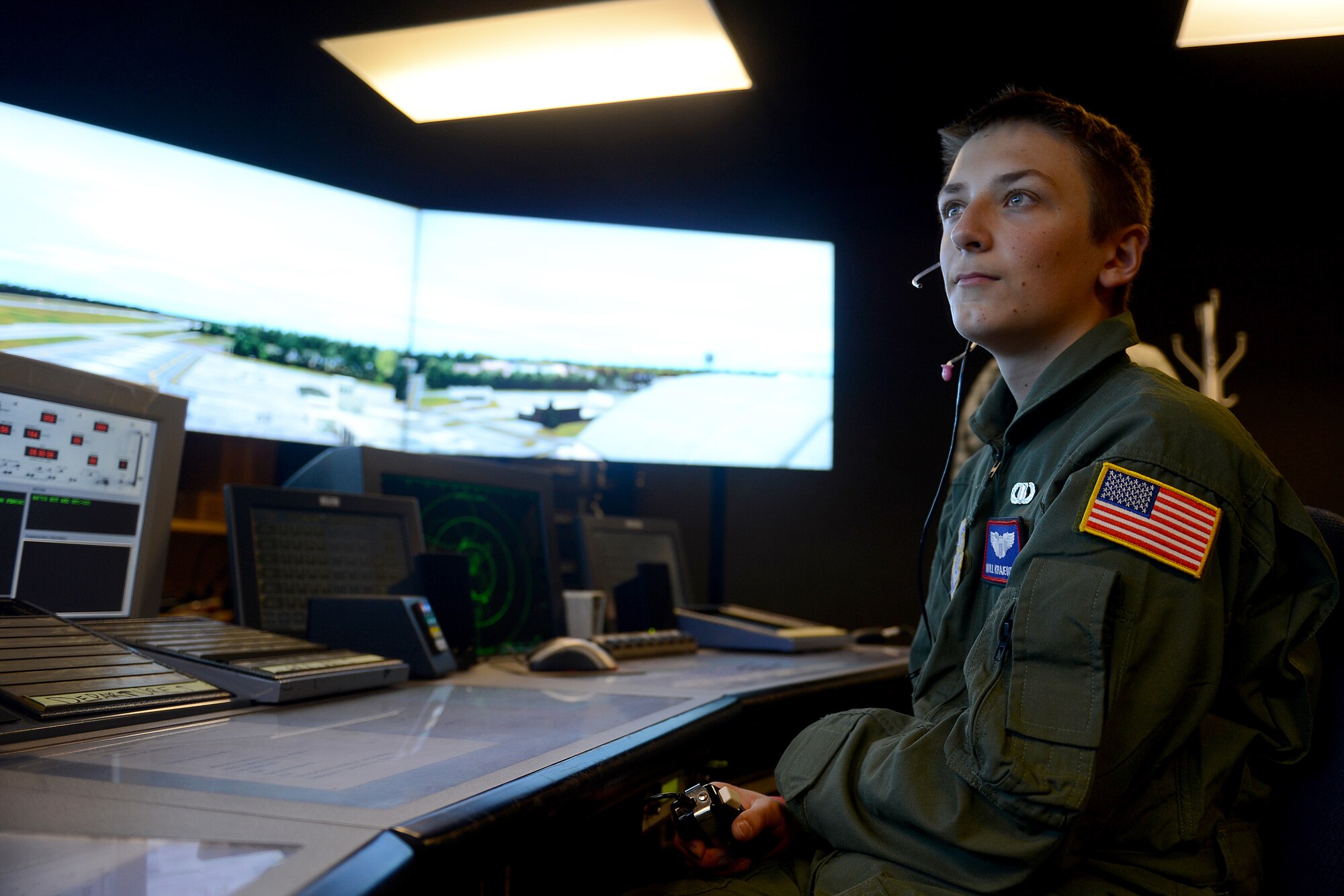Will Krajewski gives simulated commands to simulated pilots in an air traffic control simulator Sept. 19, 2014 during his Pilot for a Day tour at Joint Base Lewis-McChord, Wash. Through a microphone linked to a simulator, Krajewski commanded the pilots where to land and taxi their planes with the same commands Airmen use at a control tower. (U.S. Air Force photo/Airman 1st Class Keoni Chavarria)