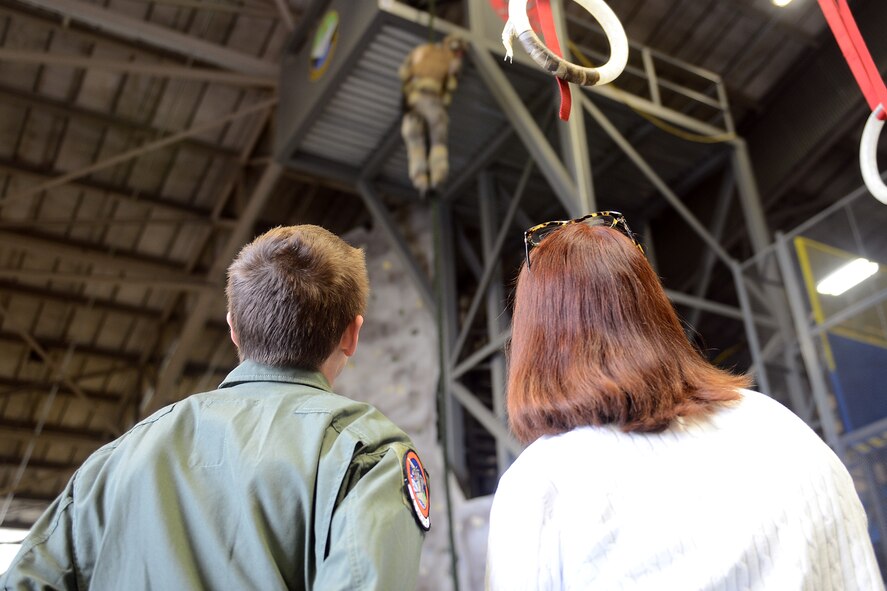 Will Krajewski (left), and his mother, Karen, watch as Staff Sgt. Mitchell Adams, 22nd Special Tactics Squadron combat controller repels down a rope, Sept. 19, 2014, during his Pilot for a Day tour at Joint Base Lewis-McChord, Washington. During the tour, Krajewski saw some of the Airmen's duties during demonstrations by the 22nd STS, explosive ordnance disposal teams, control tower, and the 4th Airlift Squadron. (U.S. Air Force photo/Airman 1st Class Keoni Chavarria) 
