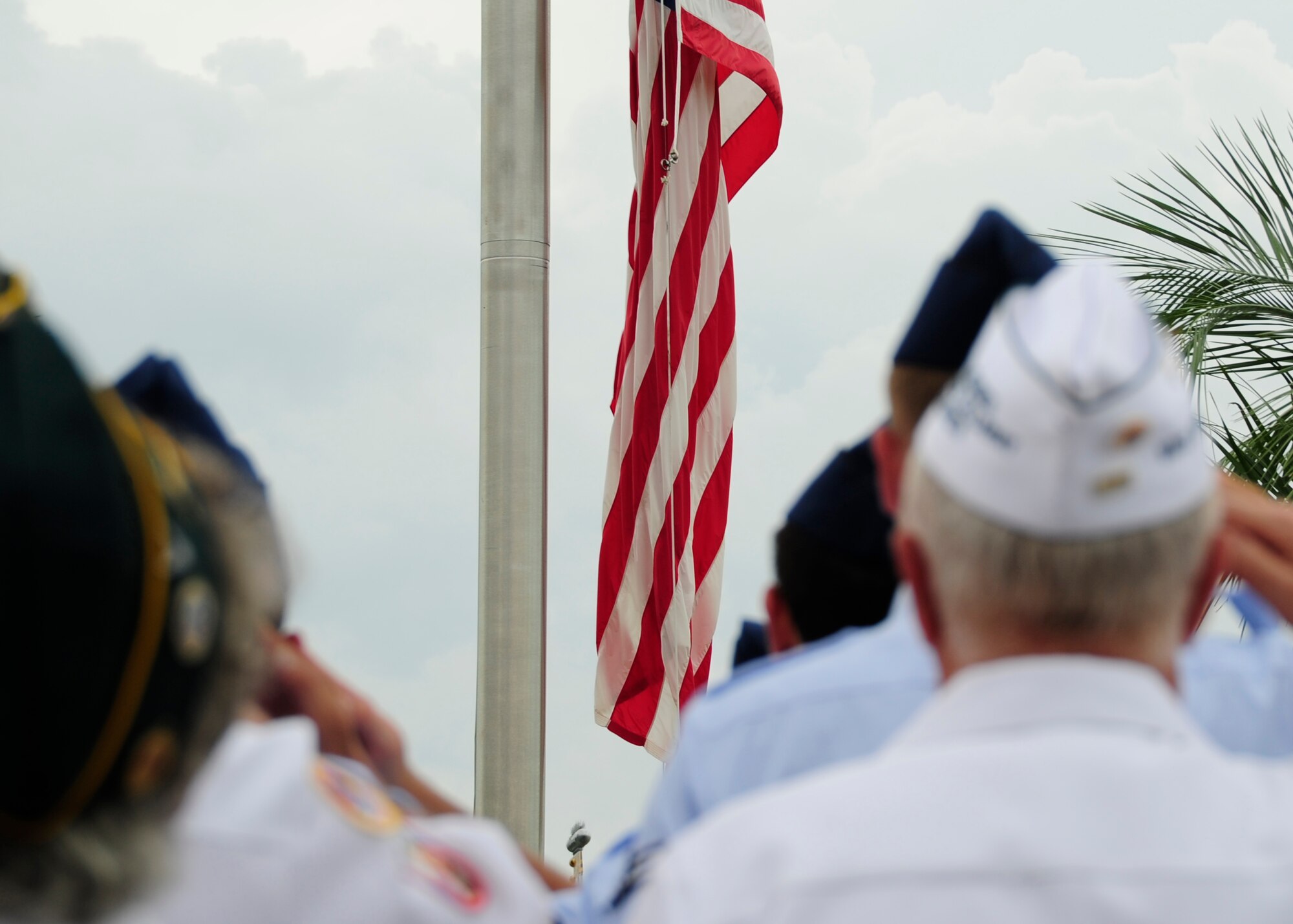 A group of Airmen and past prisoners of war stand in formation Sept. 19 for retreat at Flag Park. The retreat ceremony was part of POW/MIA Recognition Day which is held every third Friday of September. (U.S. Air Force photo by Airman 1st Class Solomon Cook)