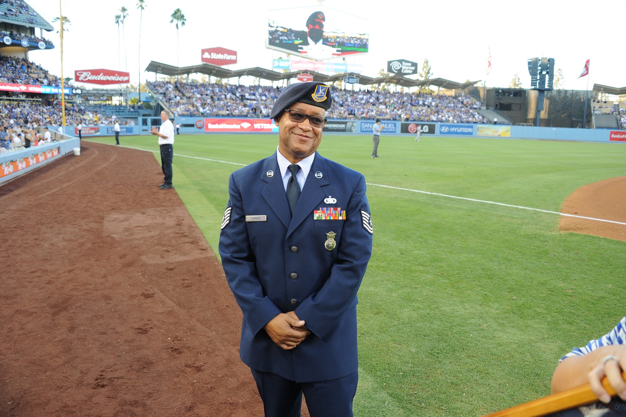 Tech. Sgt. Robert Sumner, 412th Security Forces Squadron, poses for a picture on the field during a L.A. Dodgers vs. New York Mets game Aug. 23. (Courtesy photo) 

