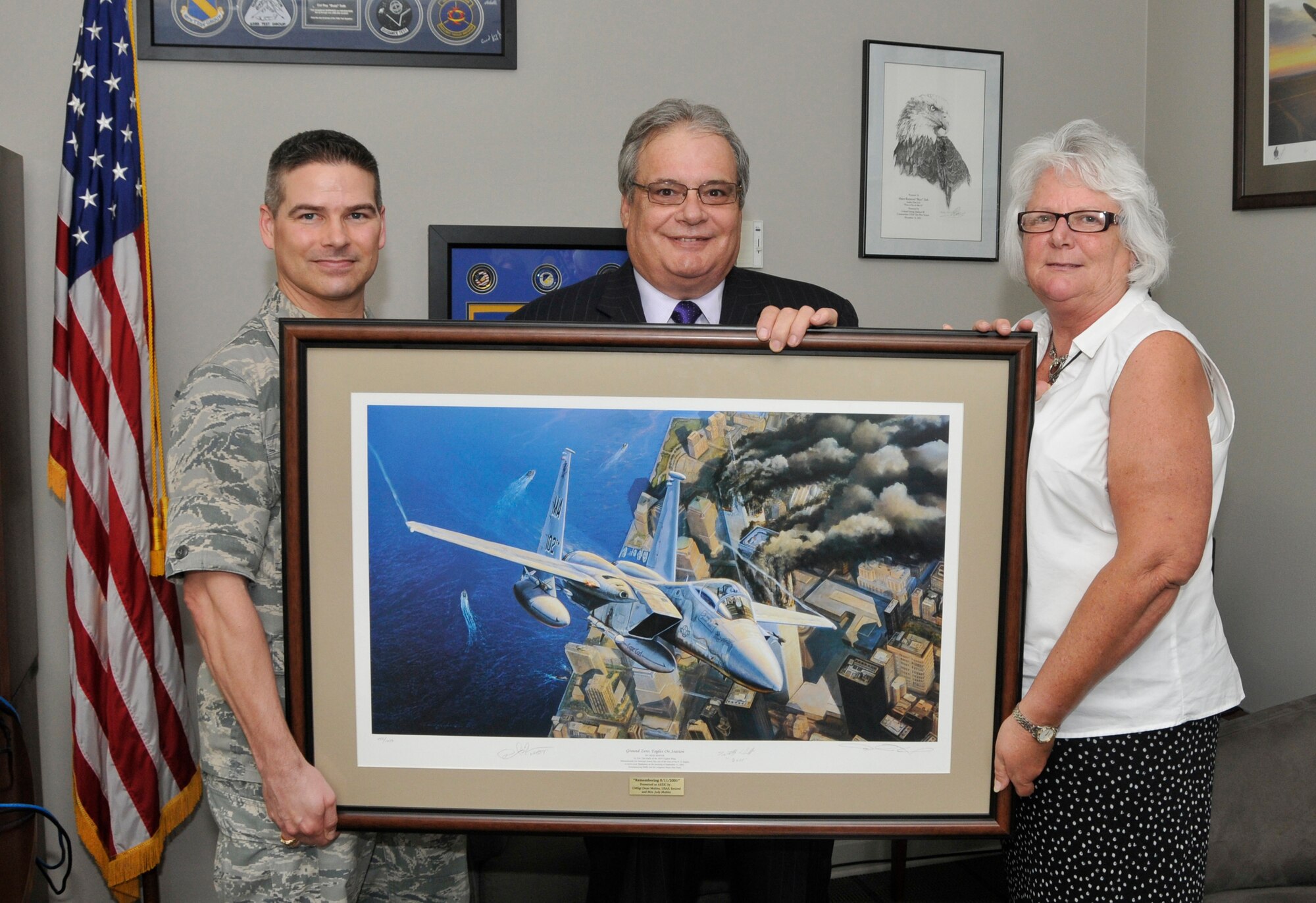 Dean and Judy Mohler, right, presenting one of the two prints to AEDC Commander Col. Raymond Toth, left. (Photo by Jacqueline Cowan) 