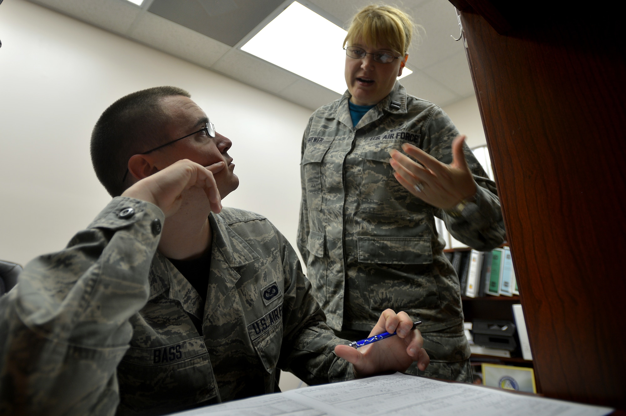 U.S. Air Force Capt. Kimberly Brewer, 20th Medical Operations Squadron clinical nurse, explains how to fill out the Department of Defense C.W. Bill Young Bone Marrow Program packet to Airman 1st Class Jonathan Bass, 20th Fighter Wing public affairs photojournalist at Shaw Air Force Base, S.C., Sept. 19, 2014. Becoming a potential bone marrow donor starts with a simple mouth swab. (U.S. Air Force photo by Staff Sgt. Kenny Holston/Released)