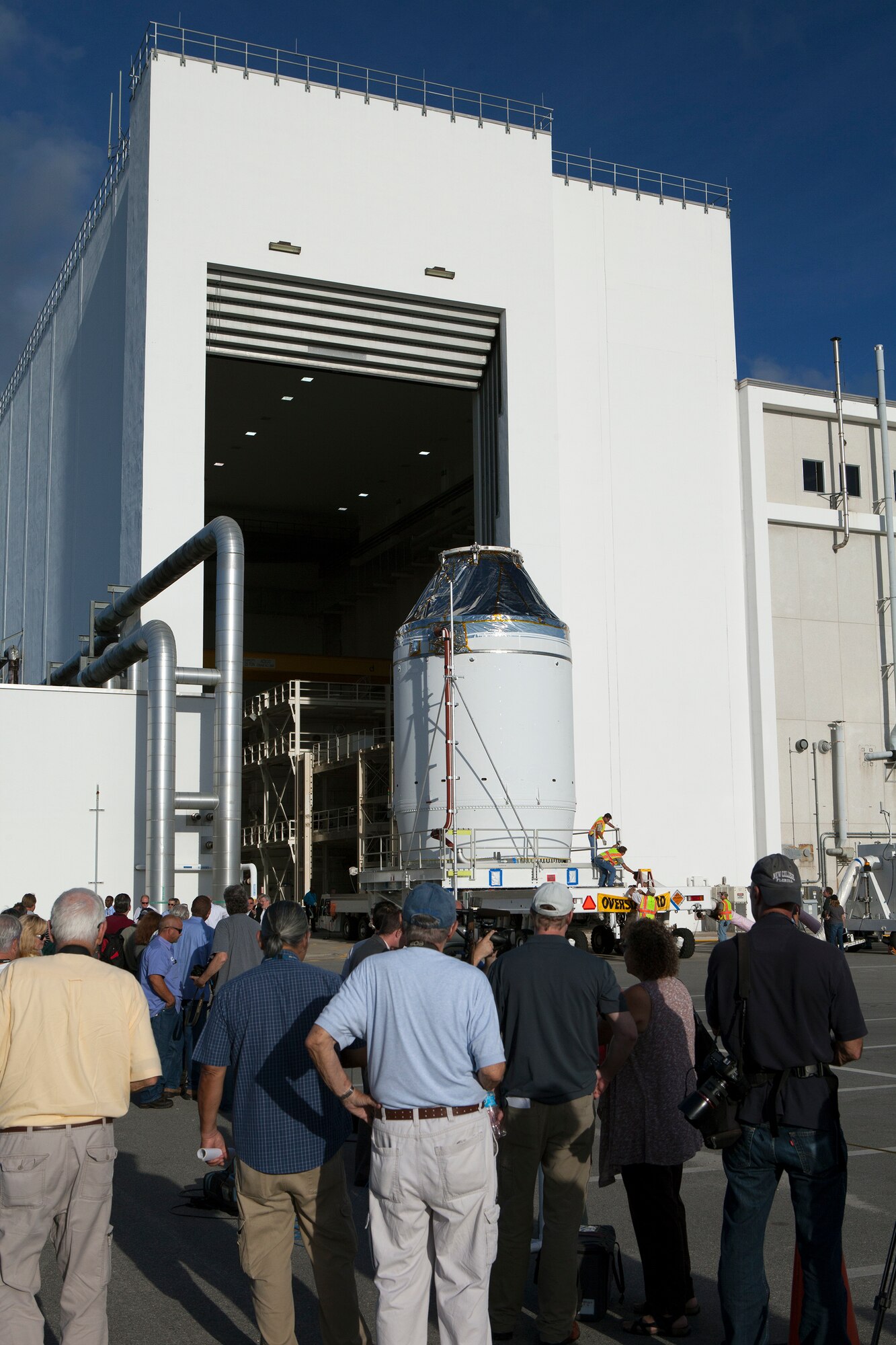 The Orion crew module, stacked atop its service module, moved out of the Neil Armstrong Operations and Checkout Building at NASA’s Kennedy Space Center in Florida on Sept 11. Orion was transported to the Payload Hazardous Servicing Facility at Kennedy where it will be fueled ahead of its December flight test. During the flight, Orion will travel 3,600 miles into space to test the spacecraft systems before humans begin traveling in Orion on future missions. (Photo by Dan Casper, NASA)
