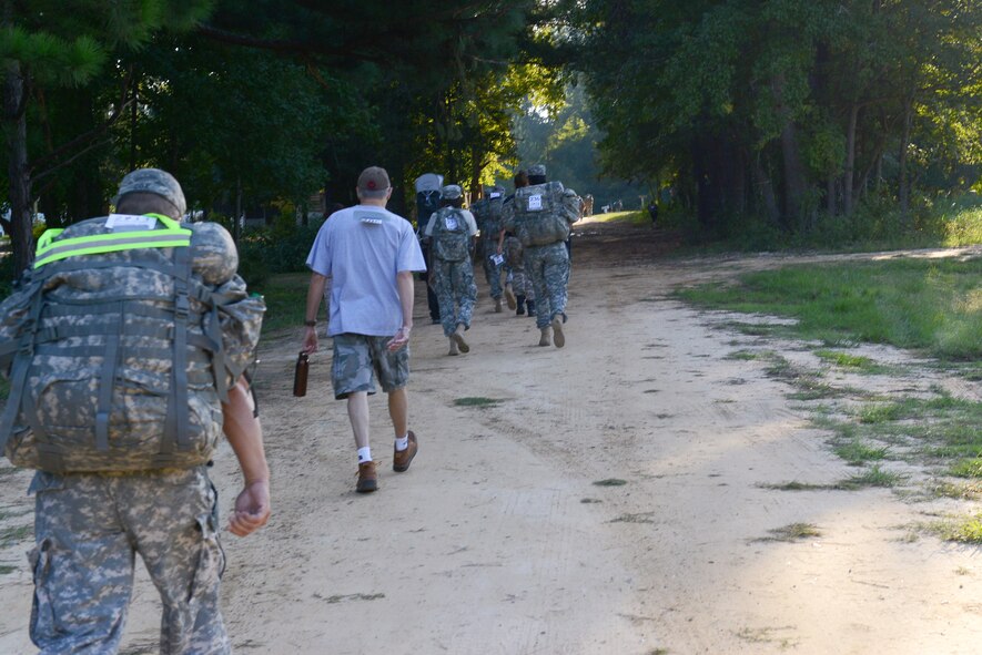 Participants of the Hurricane Hike, including military members and first responders, trek down a dirt road in Camden, S.C., Sept. 20, 2014. At the end of the course, the S.C. State National Guard provided Family Day activities including games, prizes, and inflatables. (U.S. Air Force photo by Airman 1st Class Diana M. Cossaboom/Released)
