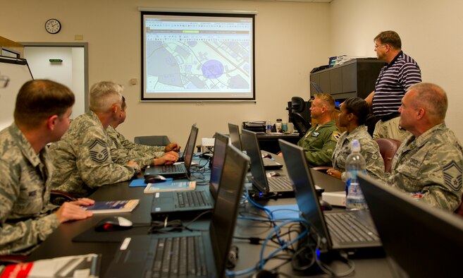 Ronald Cook, 325th Fighter Wing Plans and Programs Unit Level bridge to Unit Command and Control support consultant, demonstrates the UL/UC2 program to a group of people Sept. 9 in the XP office. UL/UC2 is a computer messaging system that allows XP to push important information, instructions and alerts to unit control centers across the base during exercise and real-world crisis periods. (U.S. Air Force photo by Airman 1st Class Alex Echols)