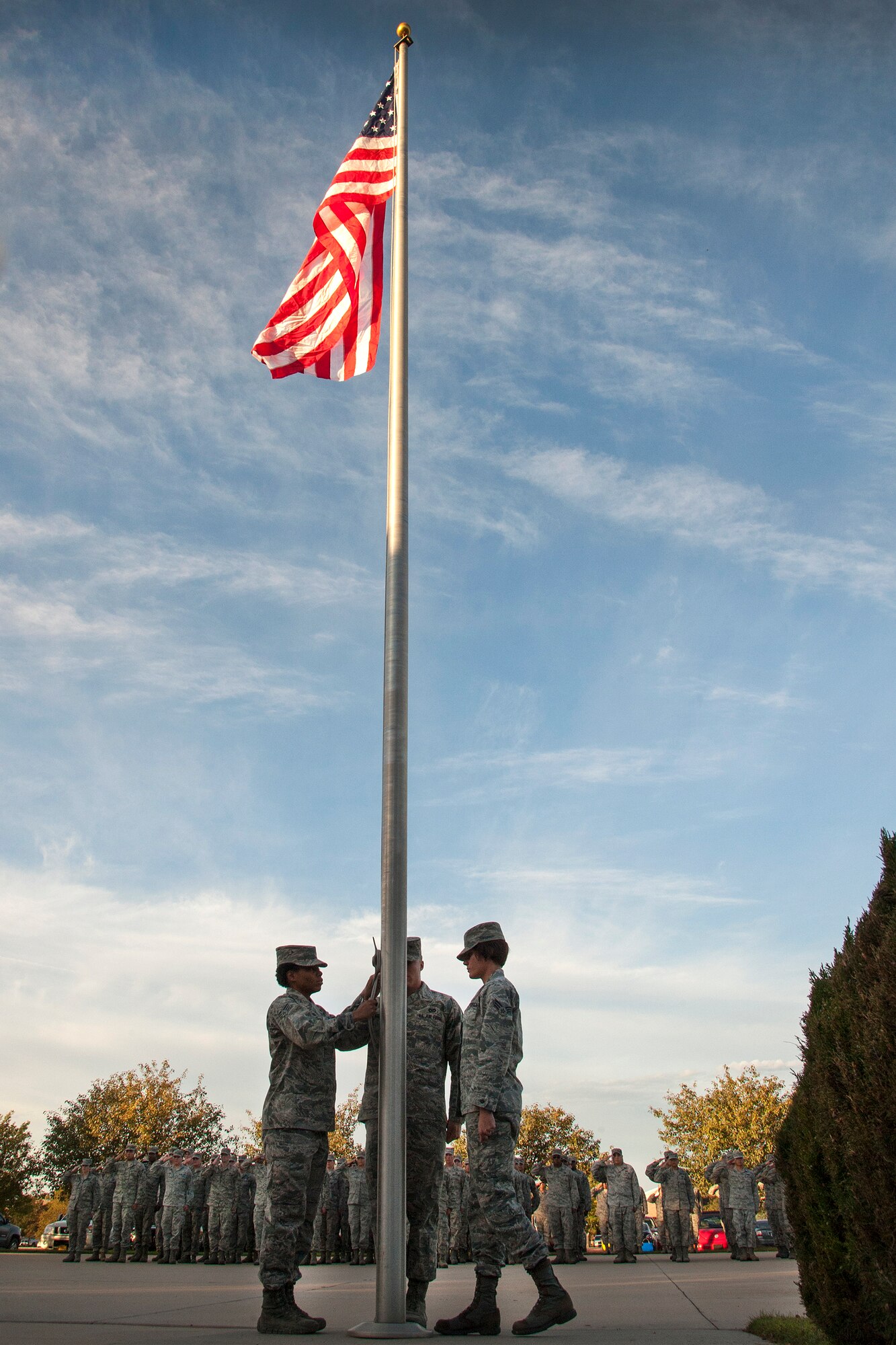 PETERSON AIR FORCE BASE, Colo. - Members of the 21st Space Wing stand in formation during the POW/MIA recognition reveille ceremony Sept. 17 at the Vossler NCO Academy. 21st SW members held a reveille and retreat ceremony recognizing the sacrifices of POWs and MIAs. (U.S. Air Force photo/Craig Denton)
