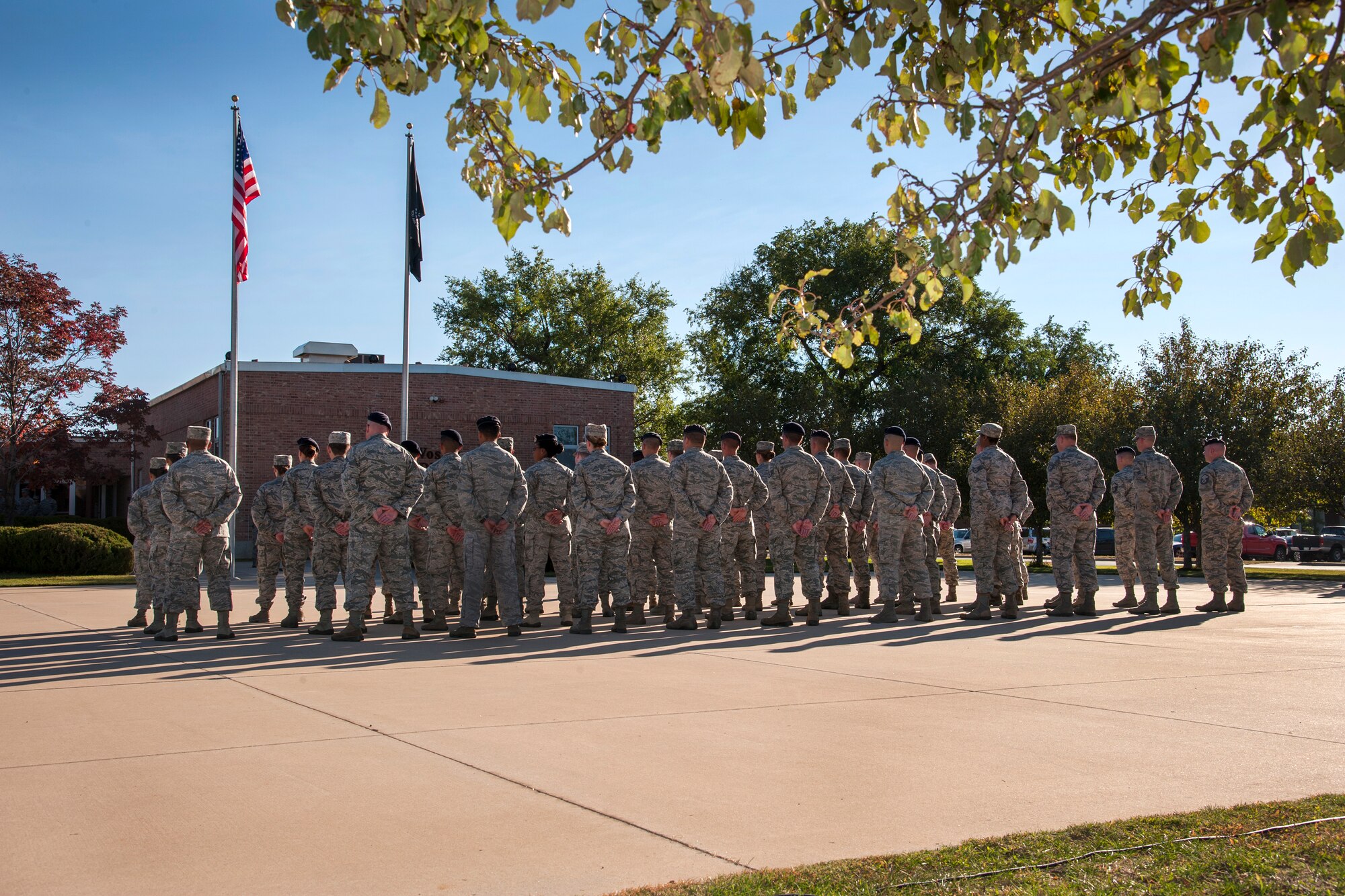PETERSON AIR FORCE BASE, Colo. - Members of the 21st Space Wing stand in formation during the POW/MIA recognition retreat ceremony Sept. 18 at the Vossler NCO Academy. 21st SW members held a reveille and retreat ceremony recognizing the sacrifices of POWs and MIAs. (U.S. Air Force photo/Craig Denton)