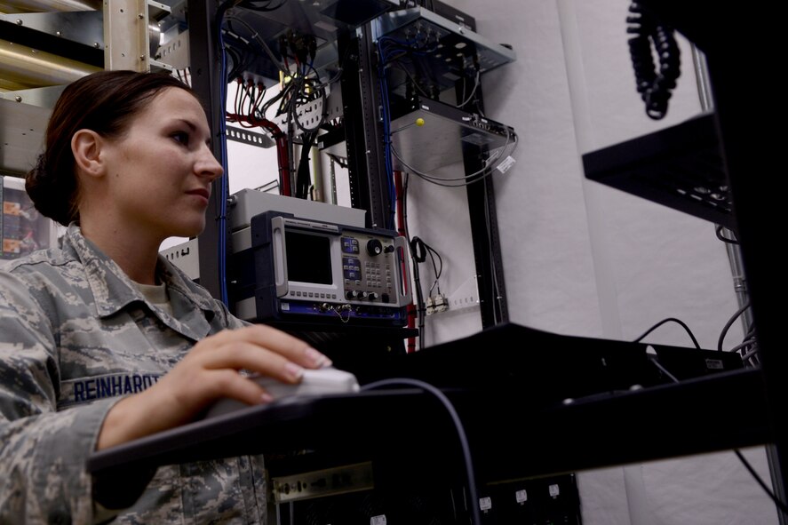 U.S. Air Force Airman 1st Class Dara Reinhardt, 20th Communication Squadron radio frequency transmission system apprentice, monitors activity on the base land mobile radio system at Shaw Air Force Base, S.C., Sept. 19, 2014. The trunk system only allows Shaw AFB radio sources to communicate with each other. (U.S. Air Force photo by Senior Airman Ashley Gardner/Released)