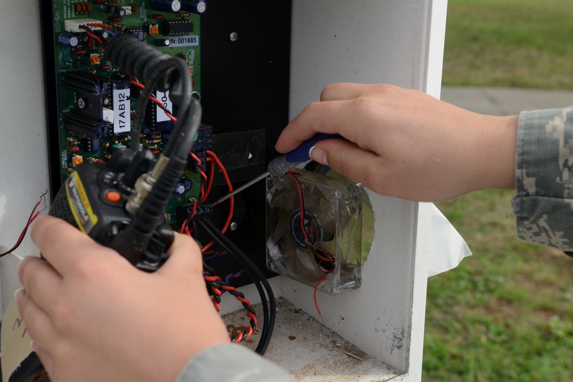 U.S. Air Force Airman 1st Class Dara Reinhardt, 20th Communication Squadron radio frequency transmission system apprentice, troubleshoots a base emergency call box at Shaw Air Force Base, S.C., Sept. 19, 2014. When pushed, the button on the box notifies first responders of an emergency. (U.S. Air Force photo by Senior Airman Ashley Gardner/Released)