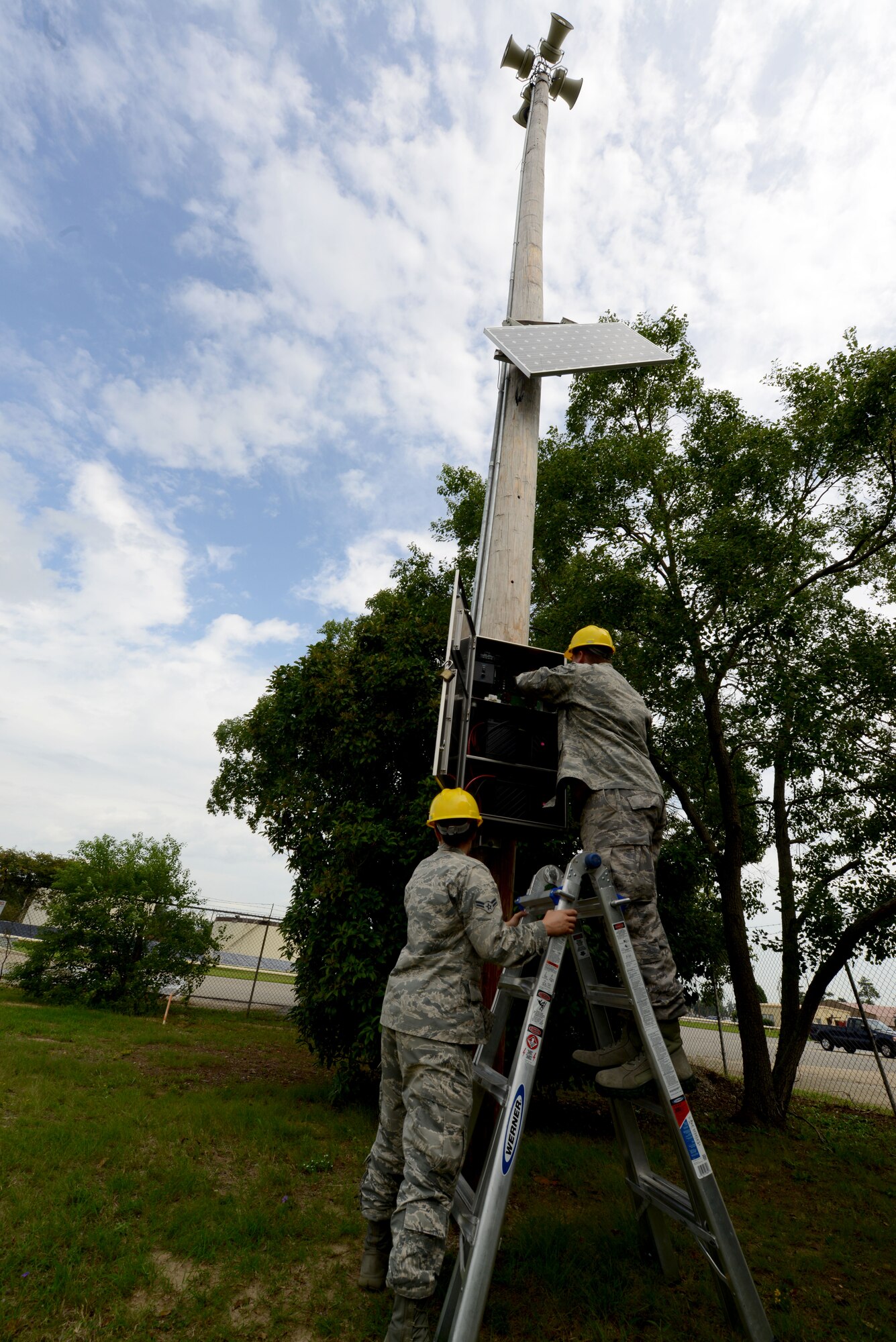U.S. Air Force Airman 1st Class Tyler Jarrard and Airman 1st Class Dara Reinhardt, both 20th Communication Squadron radio frequency transmission system apprentices, test the Shaw sound system at Shaw Air Force Base, S.C., Sept. 19, 2014. The Airmen are part of a nine person shop that specializes in radio maintenance for Shaw. (U.S. Air Force photo by Senior Airman Ashley Gardner/Released)