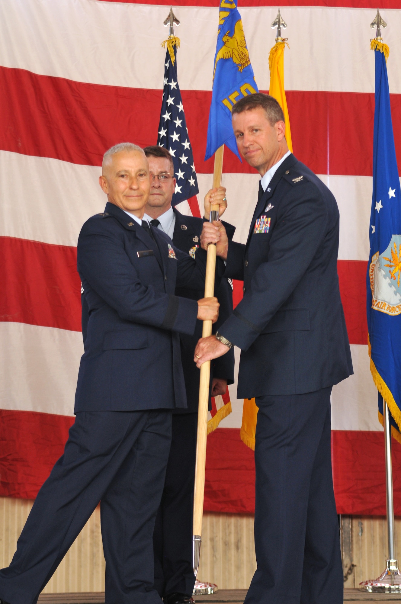 Col. Robert Reyner, right, is handed the 150th Special Operations Wing guidon from Brig. Gen. Andrew Salas, the adjutant general for the New Mexico Guard at a change of command ceremony Sept. 13. Reyner became the second commander of the unit since it went from a fighter wing to a special operations wing. (Courtesy photo)