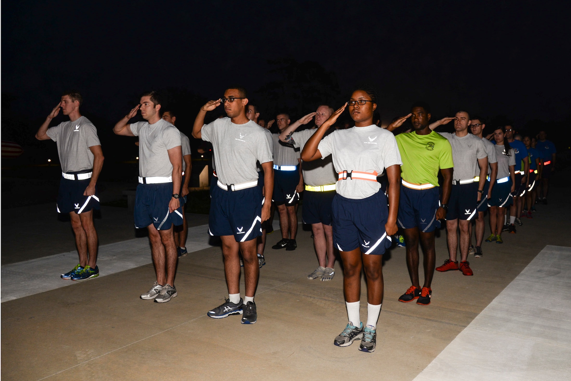 Airmen from the 23d Wing Staff Agencies and Comptroller Squadron render a salute as the national anthem plays Sept. 19, 2014, at Moody Air Force Base, Ga. The 23d WSA and CPTS kicked off this year’s Tiger-thon run by completing the first mile. (U.S. Air Force photo by Senior Airman Sandra Marrero/Released)
