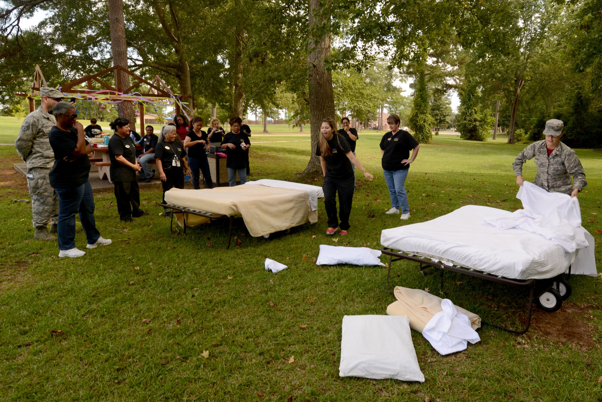 Carolina Pines Inn staff and leadership gather for the bed making contest during International Housekeeping Week at Shaw Air Force Base, S.C., Sept. 19, 2014. 
During the week, several Air Force bases provided time for housekeepers to bond and have fun with their job. (U.S. Air Force photo by Senior Airman Ashley L. Gardner/ Released) 
