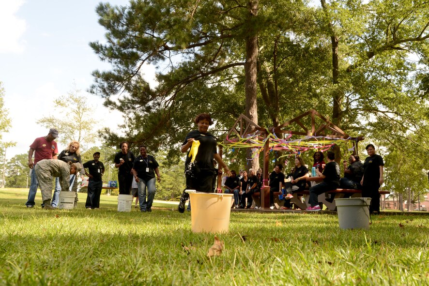 Carolina Pines Inn staff and leadership gather for the glove race event during International Housekeeping Week at Shaw Air Force Base, S.C., Sept. 19, 2014. International Housekeeping Week is an Air Force-wide event, held to show appreciation for the hard work that housekeepers do at lodging locations. (U.S. Air Force photo by Senior Airman Ashley L. Gardner/ Released)