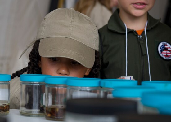 A Team Holloman youth “deployer” inspects different animals often encountered in a deployed location during Operation Kids Investigating Deployment at Holloman Air Force Base N.M., Sept. 22. Operation K.I.D. is an event put on for military youth that teaches them the deployment process. Youth ages 5-13 go through a mock deployment at the 49th Materiel Maintenance Group and receive military orders, gear and a uniform. The children also learn about safety and the conditions of their mock destination. This annual event is held to give kids a better understanding on what it’s like when their loved ones prepare for deployment. (U.S. Air Force photo by Senior Airman Leah Ferrante/Released)
