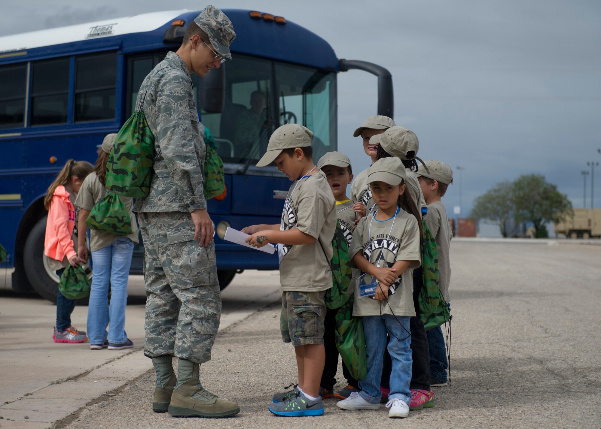 Team Holloman youth “deployers” get off the buses at their deployed location and await the beginning of chalks during Operation Kids Investigating Deployment at Holloman Air Force Base N.M., Sept 22. Operation K.I.D. is an event put on for military youth that teaches them the deployment process. Youth ages 5-13 go through a mock deployment at the 49th Materiel Maintenance Group and receive military orders, gear and a uniform. The children also learn about safety and the conditions of their mock destination. This annual event is held to give kids a better understanding on what it’s like when their loved ones prepare for deployment. (U.S. Air Force photo by Senior Airman Leah Ferrante/Released) 
