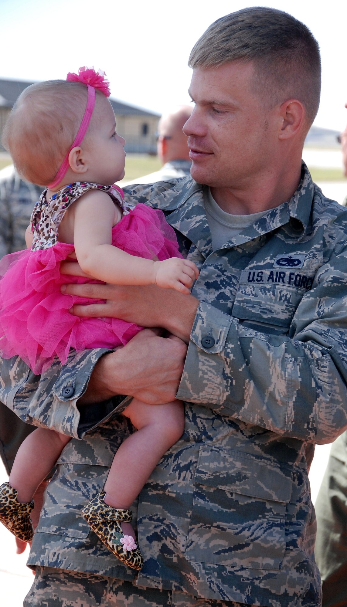 Tech. Sgt. Ryan Chandler, 931st Maintenance Squadron Crew Chief, holds his daughter, Audrey, after returning from a 120-day deployment to Southwest Asia at McConnell Air Force Base, Sept. 22, 2014.  Chandler and 15 other members of the 931st Air Refueling Group deployed to support the 379th Air Expeditionary Wing.  (U.S. Air Force photo by Staff Sgt. Abigail Klein)