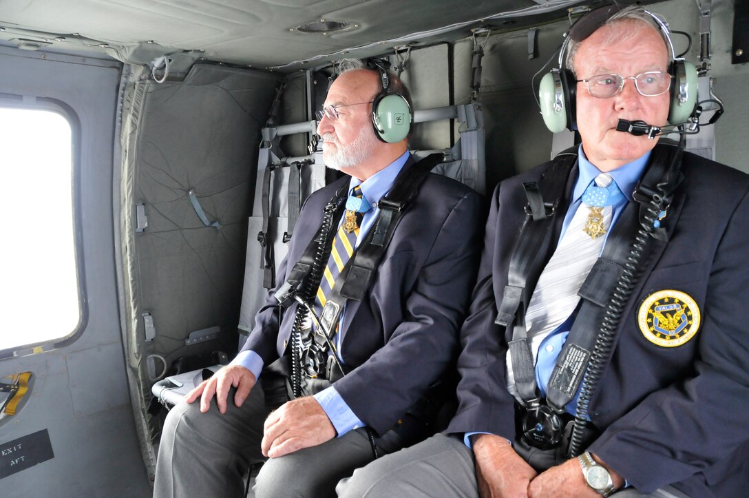 Congressional Medal of Honor recipients 1Lt Brian Thacker and Command Sergeant Maj. Robert Patterson take in the view of East Tennessee from an Army National Guard Blackhawk helicopter on thier way to speak to students at a local high school while in Knoxville, Tennessee for the 2014 Medal of Honor Convention. (U.S. Air National Guard photo by Master Sgt. Kendra M. Owenby, 134 ARW Public Affairs)