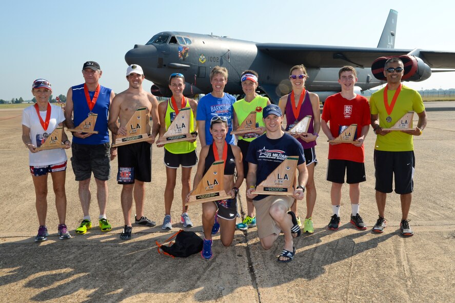 Barksdale Half-Marathon and 5k winners pose for a photo with Col. Kristin Goodwin, 2nd Bomb Wing commander on Barksdale Air Force Base, La., Sept. 20, 2014. Awards were given out to the fastest male and female runners based on age group. (U.S. Air Force photo/Airman 1st Class Benjamin Raughton)