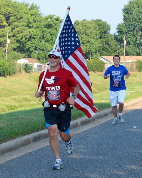 Lt. Col. Bryan Patchen, 11th Bomb Squadron and Staff Sgt. Christopher Wall, 2nd Civil Engineer Squadron, participate in the Barksdale Half-Marathon and 5K on Barksdale Air Force Base, La., Sept. 20, 2014. The 13-mile course took runners across the flightline and base housing. (U.S. Air Force photo/Airman 1st Class Benjamin Raughton)