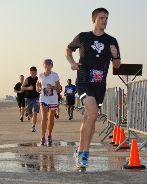 Runners persevere at the midway point of the half-marathon and 5K run on Barksdale Air Force Base, La., Sept. 20, 2014. The run is held annually and members of the local community are invited to participate. (U.S. Air Force photo/Airman 1st Class Benjamin Raughton)