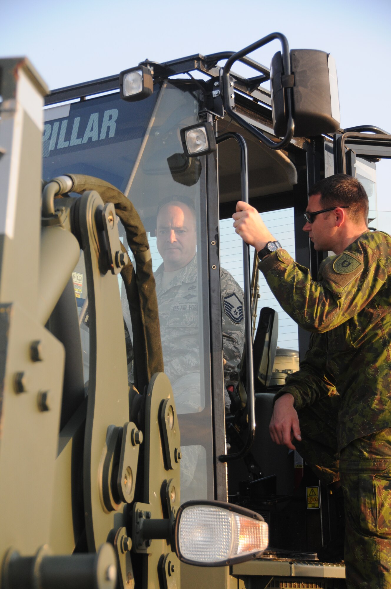 U.S. Air Force Master Sgt. Philip Shelton, left, aerial transportation specialist assigned to the 193rd Special Operations Logistics Readiness Squadron, shows Lithuanian Air Force Cpl. Vaidotas Vilnius how to operate a forklift while waiting for an aerial drop at Coyle Field Airport, Chatsworth, N.J. Sept. 18, 2014. Members of the LTAF and a member of the Latvian Air Force trained with 193rd SOLRS as part of Pennsylvania-Lithuania National Guard State Partnership Program. (U.S. Air National Guard photo by Tech. Sgt. Culeen Shaffer/Released)