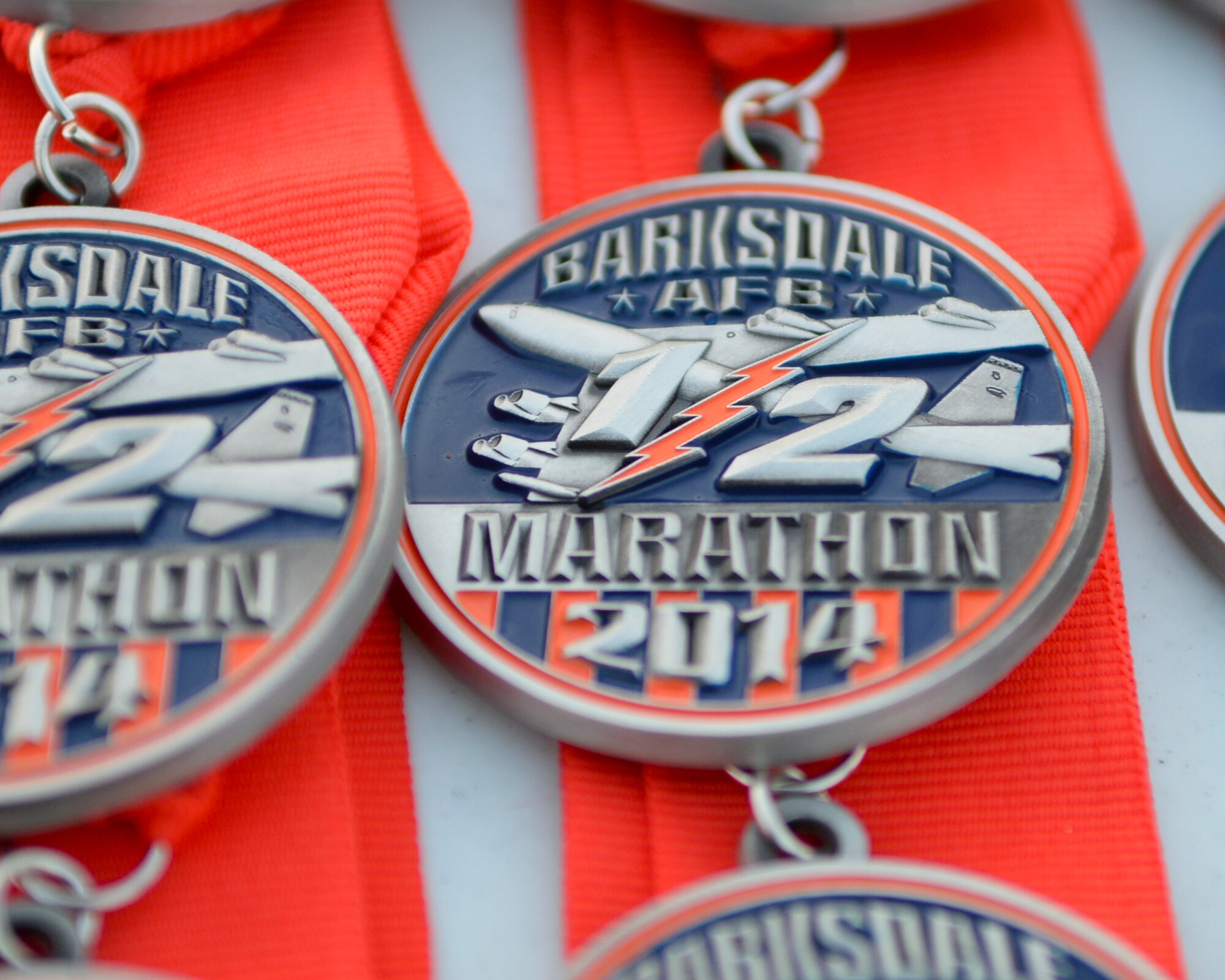 Rows of medals sit on a table near the finish line at the Barksdale Half-Marathon and 5K run on Barksdale Air Force Base, La., Sept. 20, 2014. Medals were awarded to all runners who completed their respective run. (U.S. Air Force photo/Airman 1st Class Benjamin Raughton)
