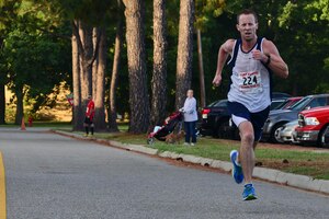 Victor Fleming of Smithfield, Va., places first 5K portion of the 33rd annual Mulberry Island Half-Marathon and 5K at Fort Eustis, Va., Sept. 20, 2014. Fleming, one of 51 5K runners, finished the race in 16:15. (U.S. Air Force photo by Airman 1st Class Kimberly Nagle/Released)