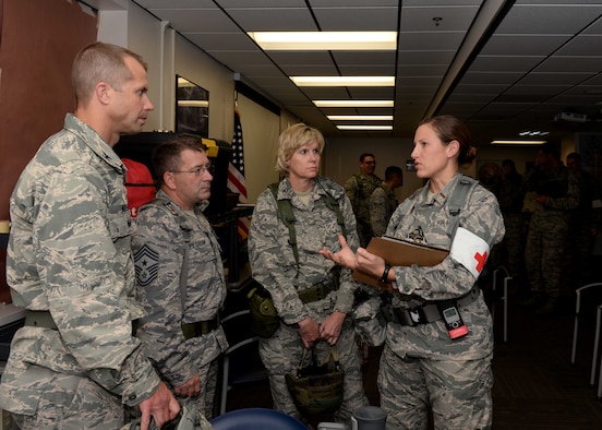Col. Ty Neuman, 28th Bomb Wing vice commander(left), Chief  Master Sgt. Kevin Peterson, 28th BW command chief, and Col. Susan Pietrykowski, 28th Medical Group commander, speak with  2nd Lt. Michelle Anderson, 28th Medical Support Squadron tri-care operations patient administration flight commander, at the clinic during an operational readiness exercise at Ellsworth Air Force Base, S.D., Sept. 15, 2014. Base leadership visited with clinic personnel to gain feedback on exercise operations.  (U.S. Air Force photo by Airman 1st Class Rebecca Imwalle/ Released)