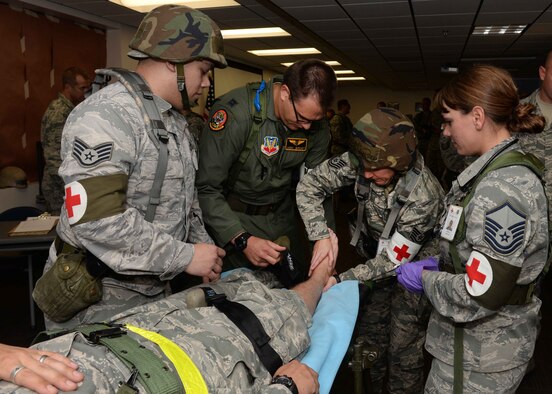 Airmen from the 28th Medical Support Squadron place a splint on a simulated leg fracture at the clinic during an operational readiness exercise at Ellsworth Air Force Base, S.D., Sept. 15, 2014. During the exercise, the 28th MDOS Airmen increased mission readiness by training on valuable life saving techniques under the increased pressure of a simulated combat environment. (U.S. Air Force photo by Airman 1st Class Rebecca Imwalle/ Released)