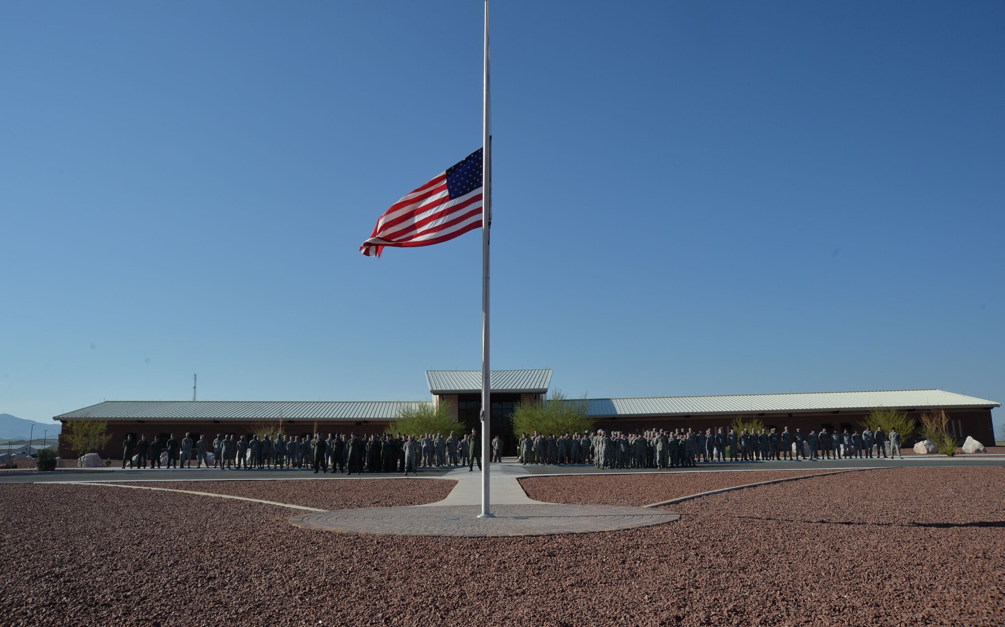 Airmen from the 432nd Wing and the 799th Air Base Group gather in formation to pay homage to those killed on Sept. 11, 2001, during a formal retreat ceremony at Creech Air Force Base, Nevada, Sept. 11, 2014. The event took place to honor those lost on Sept. 11, 2001, and those who have paid the ultimate sacrifice in the defense of our country. (U.S. Air Force photo by Tech. Sgt. Nadine Barclay/RELEASED)