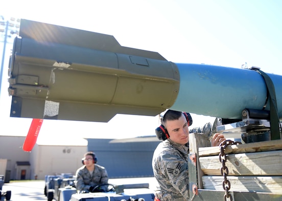 Airman 1st Class Daniel Sorters, 28th Aircraft Maintenance Squadron load crew member, secures a BDU-50 bomb onto a jammer on the flightline during an operational readiness exercise at Ellsworth Air Force Base, S.D., Sept. 15, 2014. The BDU-50 is an inert version of the 500 pound general purpose Mk 82 bomb. (U.S. Air Force photo by Airman 1st Class Rebecca Imwalle/ Released)