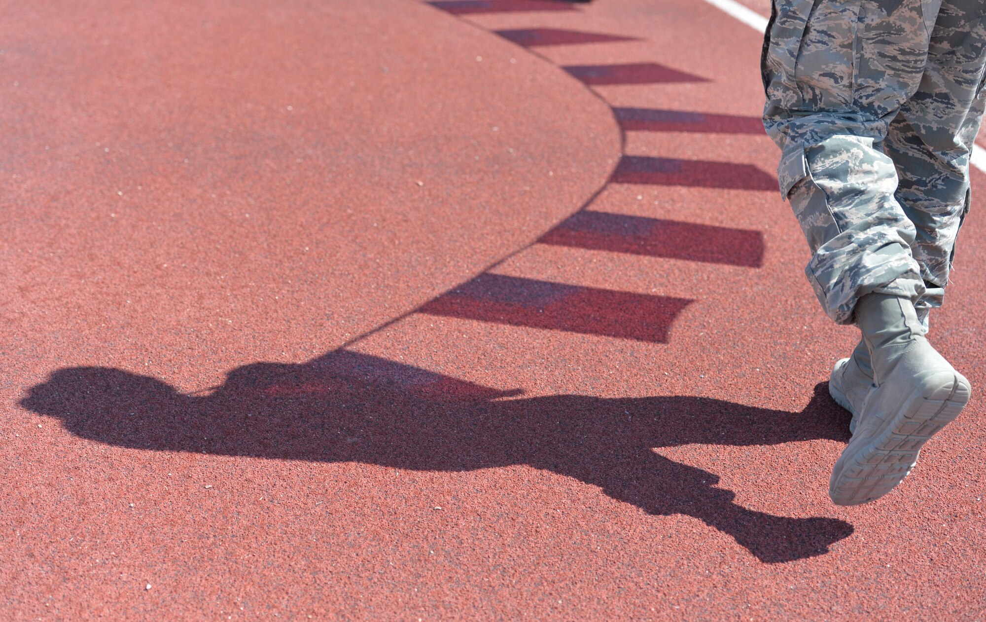An Airman from Creech Air Force Base pays homage to those lost in the Sept. 11, 2001, attack on the United States by participating in a 24-hour relay race sponsored by the Team Red, White and Blue Coast-to-Coast during the 9/11 remembrance event Sept. 11, 2014. The event took place to honor those lost on Sept. 11, 2001, and those who have paid the ultimate sacrifice in the defense of our country. (U.S. Air Force photo by Tech. Sgt. Nadine Barclay/RELEASED)