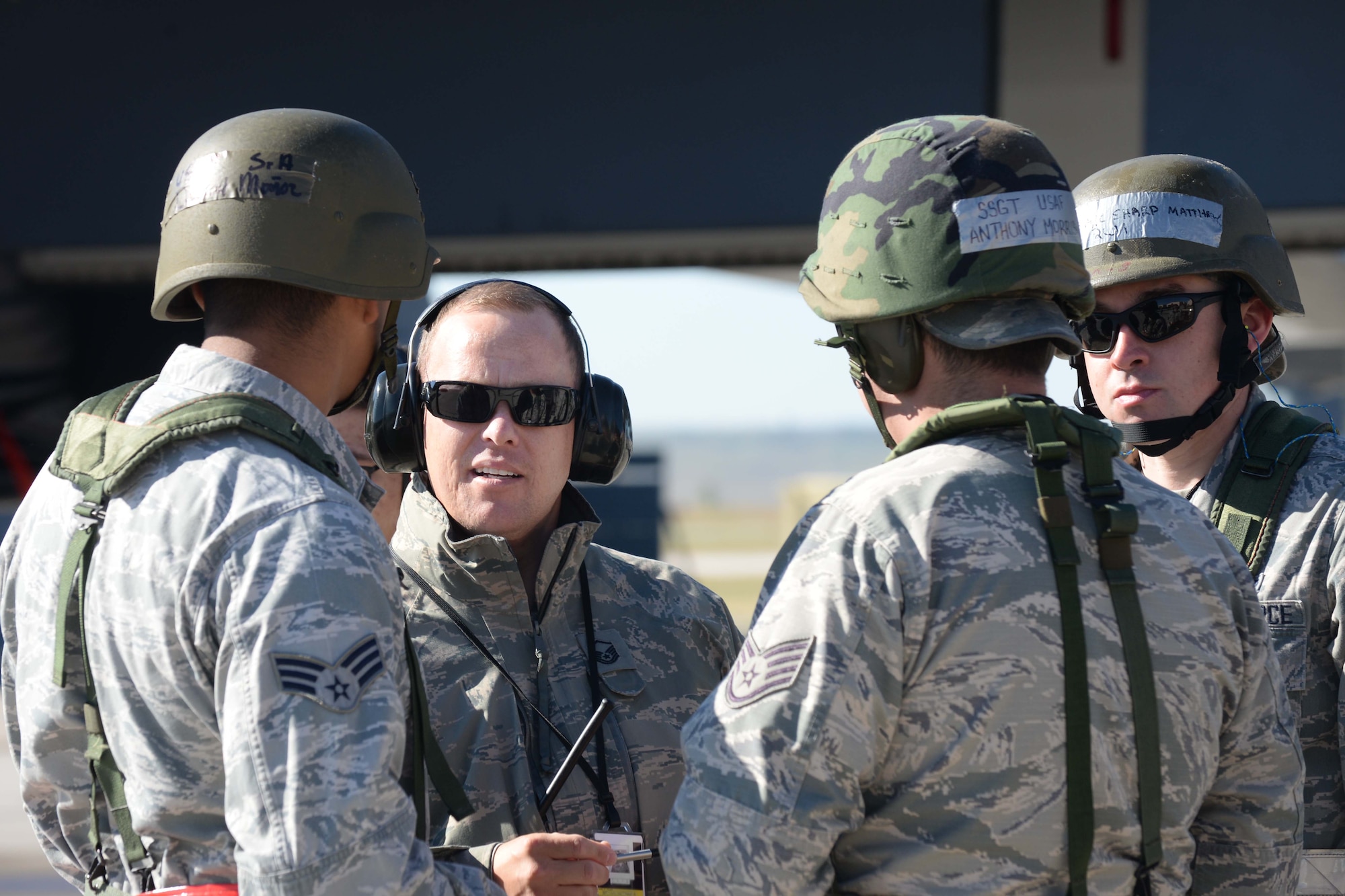 Master Sgt. Nathan Bryan, 28th Aircraft Maintenance Squadron NCO in charge of weapons loading, speaks to Airmen prior to munitions loading on the flightline during an operational readiness exercise at Ellsworth Air Force Base, S.D., Sept. 15, 2014. Crews of four Airmen loaded more than 20 bombs into aircraft during the exercise while being evaluated on the safety and effectiveness of the process. (U.S. Air Force photo by Airman 1st Class Rebecca Imwalle/Released)