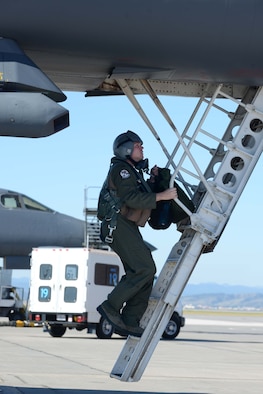 First Lt. Joseph Wilkinson, 34th Bomb Squadron weapon systems officer, boards a B-1 bomber on the flightline during an operational readiness exercise at Ellsworth Air Force Base, S.D., Sept. 15, 2014. The ORE tested Ellsworth’s capability and mission readiness to execute the mission properly while in a hostile environment. (U.S. Air Force photo by Airman 1st Class Rebecca Imwalle/Released)