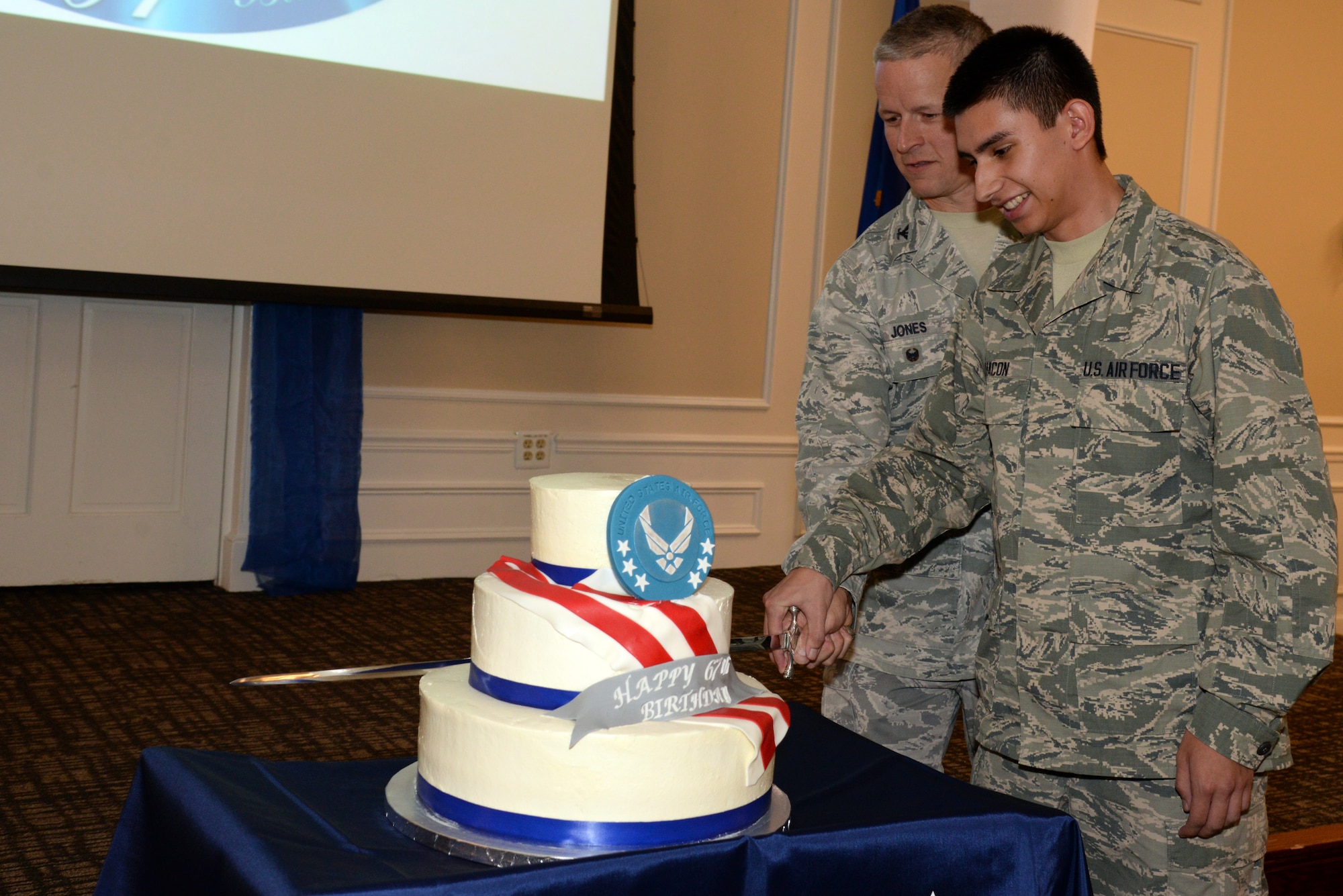 U.S. Air Force Col. Bill Jones, 20th Fighter Wing vice commander and Airman Roman Chacon, 20th Force Support Squadron reenlistments and entitlements technician, cut the birthday cake at the Air Force’s 67th Birthday celebration at Shaw Air Force Base, S.C., Sept. 18, 2014. Tradition dictates that the lowest ranking Airman cuts the cake with the highest ranking Airman. (U.S. Air Force photo by Airman 1st Class Jonathan Bass/Released)