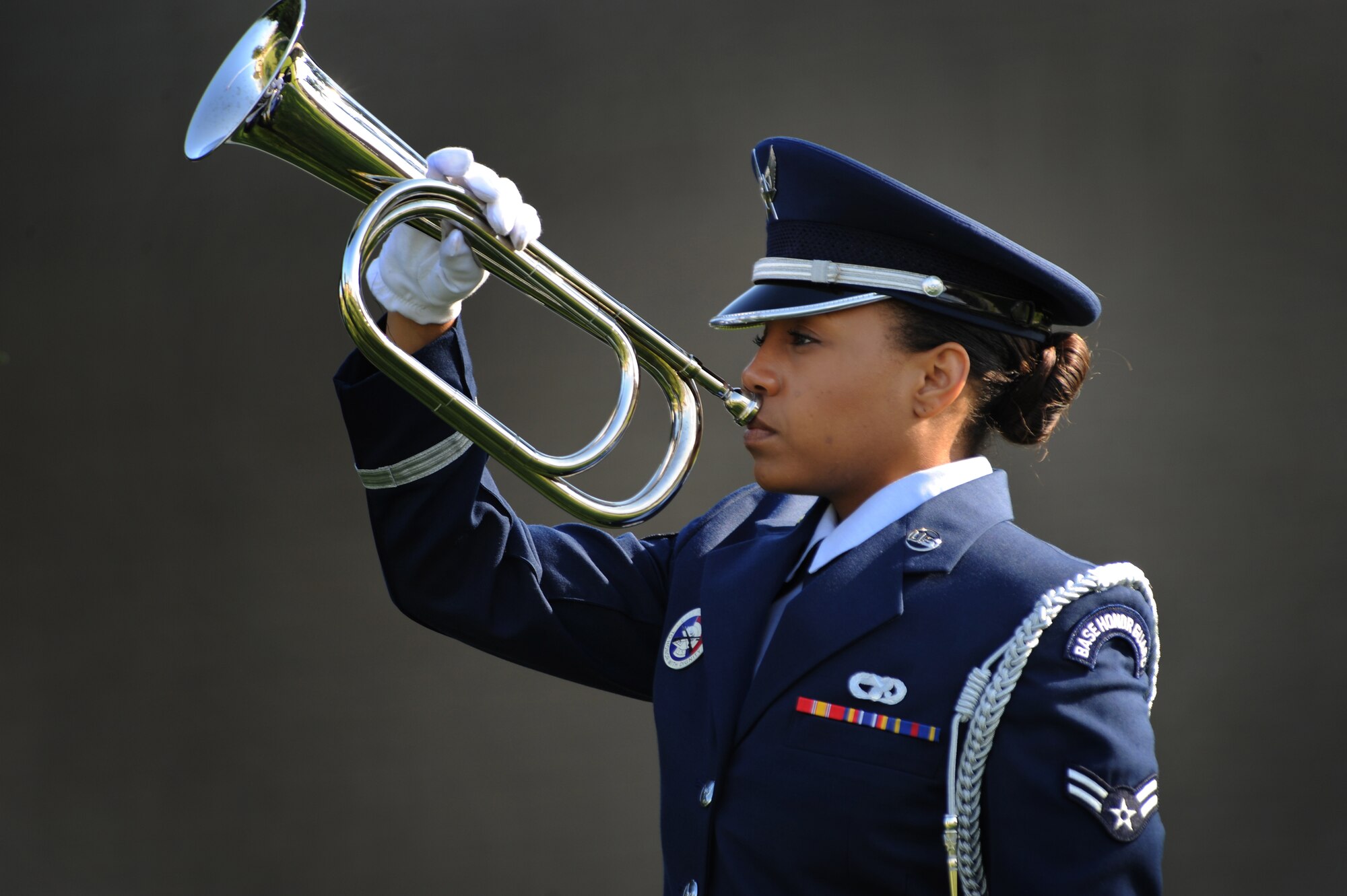 Airman 1st Class Rashaunda Chapman, Base Honor Guard, simulates playing taps during POW/MIA Remembrance Day retreat ceremony Sept. 19, 2014 at Dover Air Force Base, Del. The Honor Guard performed retreat, taps and a 21-gun salute at the ceremony. (U.S. Air Force photo/Staff Sgt. Elizabeth Morris)