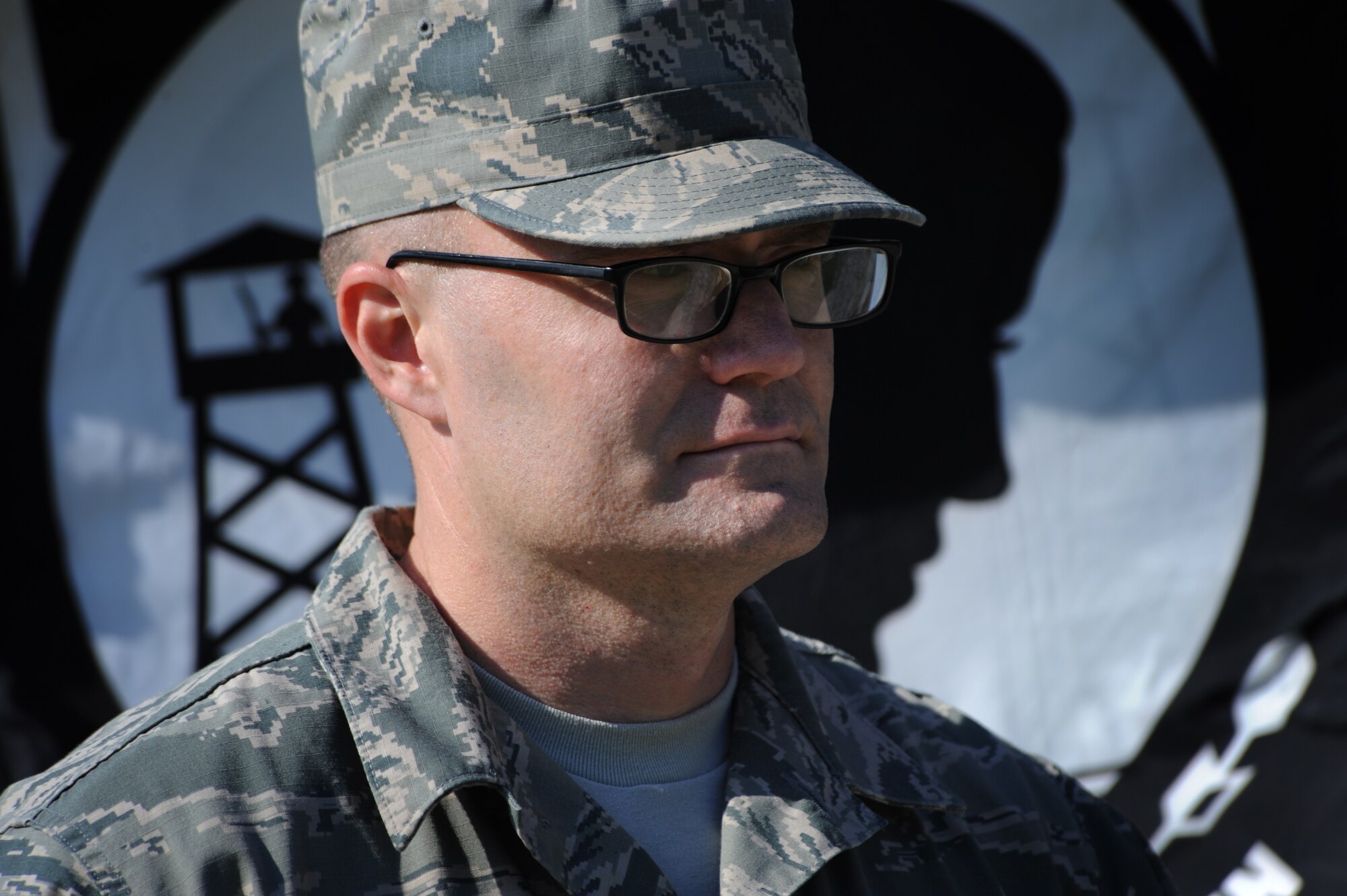 Master Sgt. Keith Eberhardt, 436th Medical Group first sergeant, stands with the prisoner of war/missing in action flag during a POW/MIA Remembrance Day retreat ceremony Sept. 19, 2014 at Dover Air Force Base, Del. Team Dover took time to honor those listed as POW or MIA by participating in a run, vigil and retreat ceremony Sept. 18-19. (U.S. Air Force photo/Staff Sgt. Elizabeth Morris)